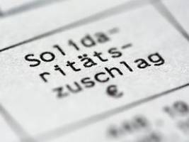 solidaritätszuschlag bleibt: große enttäuschung für unternehmen und steuerzahler