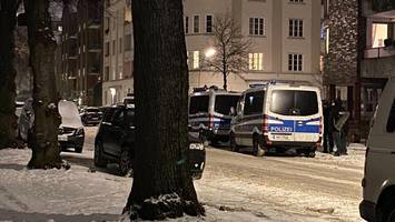 einschusslöcher in fensterscheibe? schwer bewaffnete polizisten rücken an